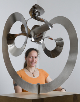 Hinke Osinga with the steel sculpture `Manifold', August 2008; credit: Jason Ingram, University of Bristol
